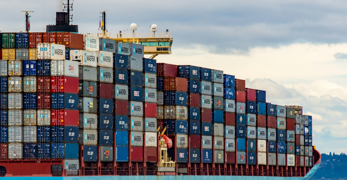 blue and red cargo ship on sea during daytime