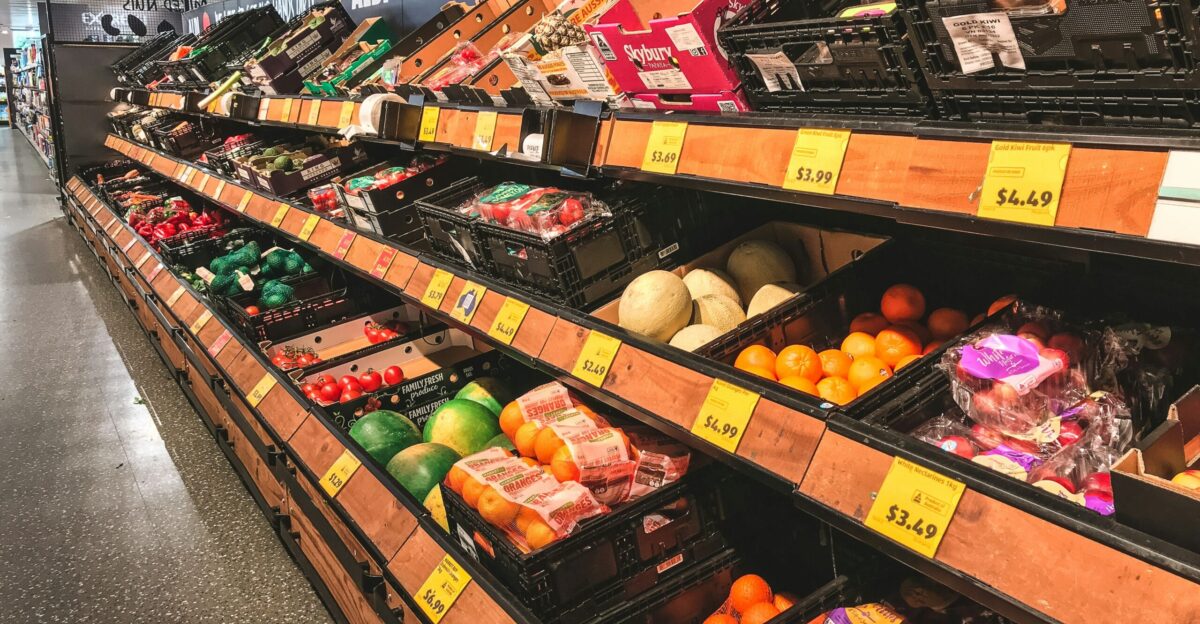 assorted fruits on brown wooden shelf