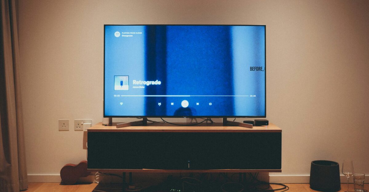 black flat screen tv on brown wooden tv rack