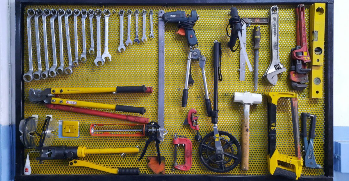 assorted hand tools on brown floor