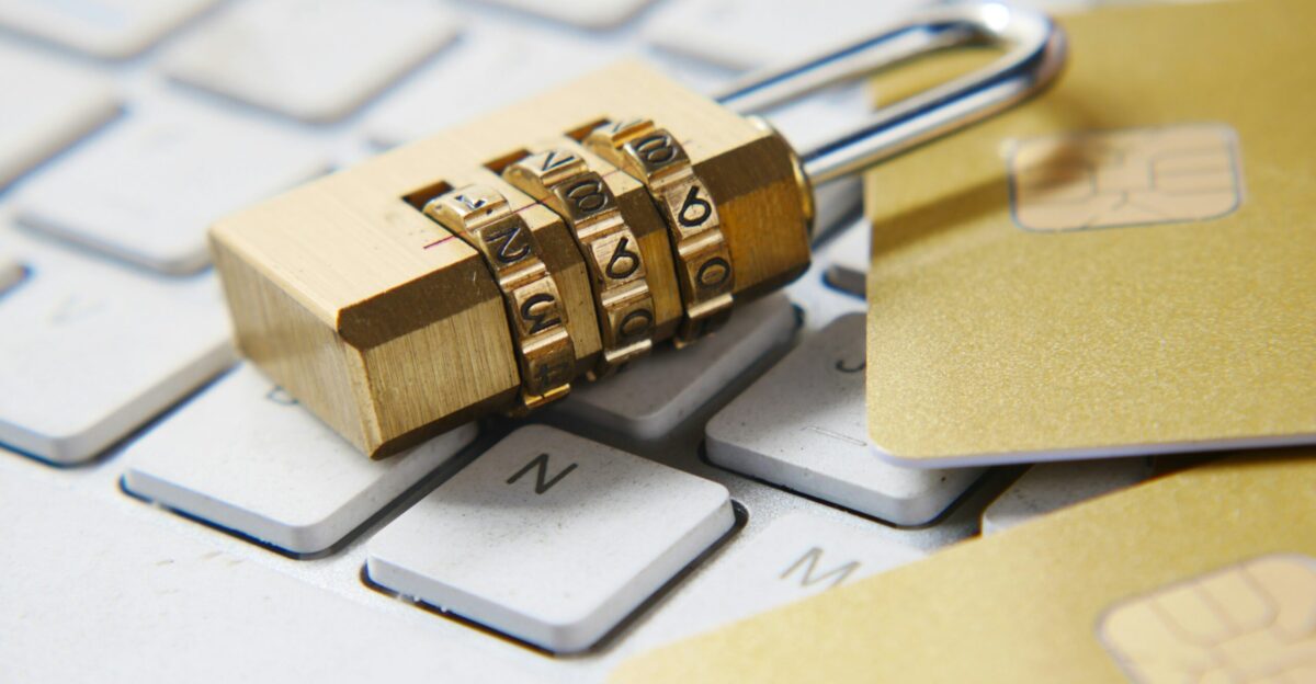 a golden padlock sitting on top of a keyboard