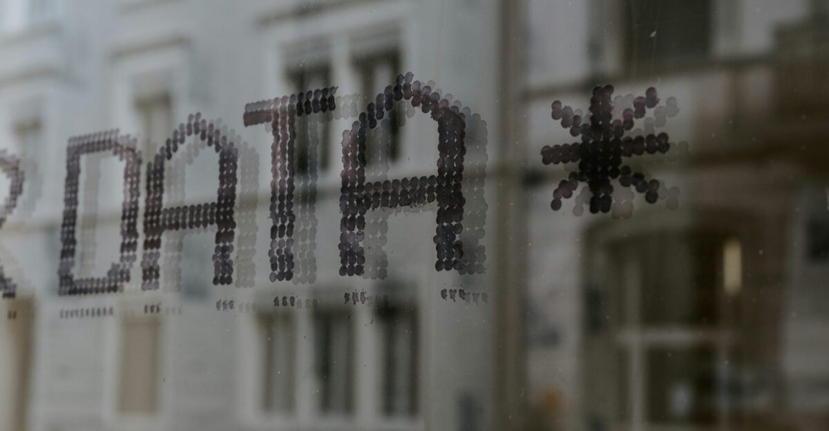 a close up of a window with a building in the background