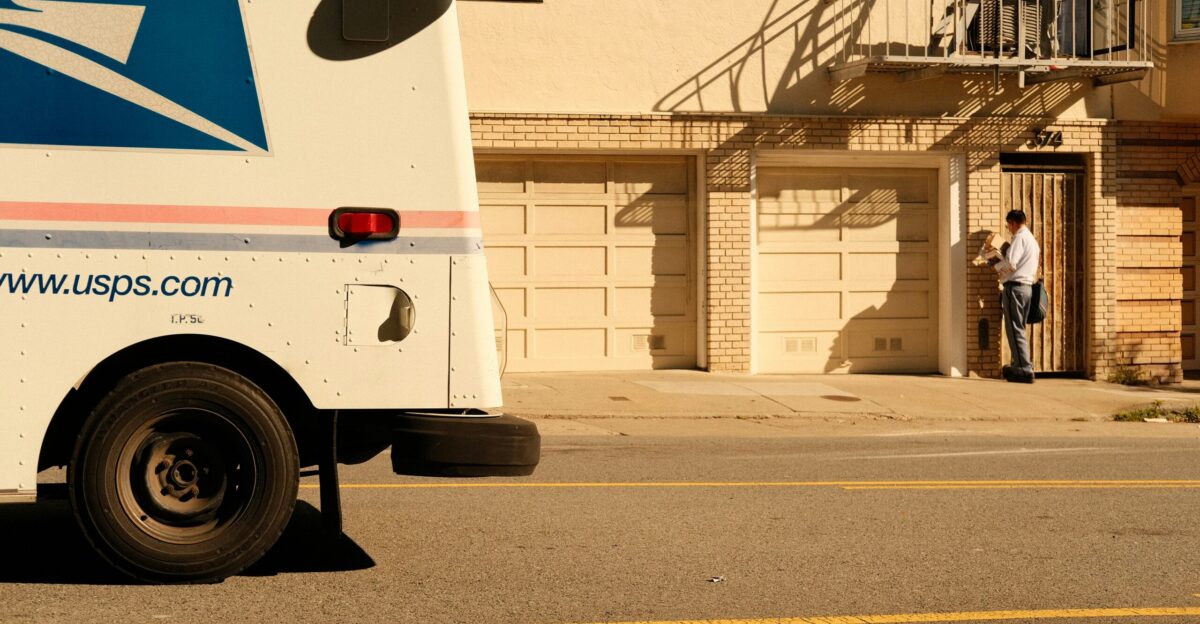 a mail truck parked on the side of the road