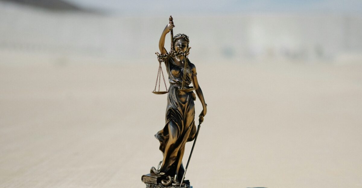 a statue of a lady justice holding a scale