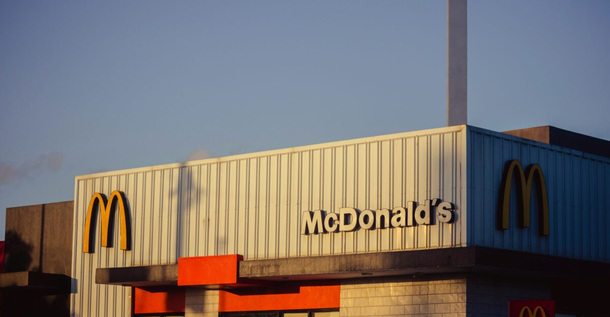 a mcdonald s restaurant with a smoke stack sticking out of the roof