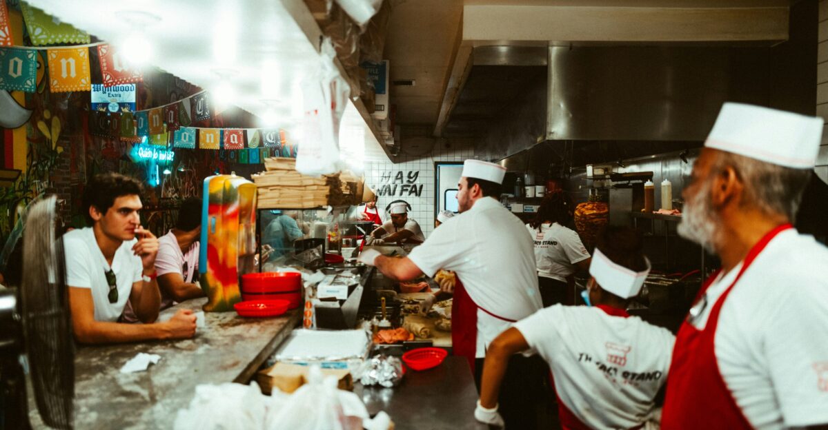 a group of people in a kitchen preparing food