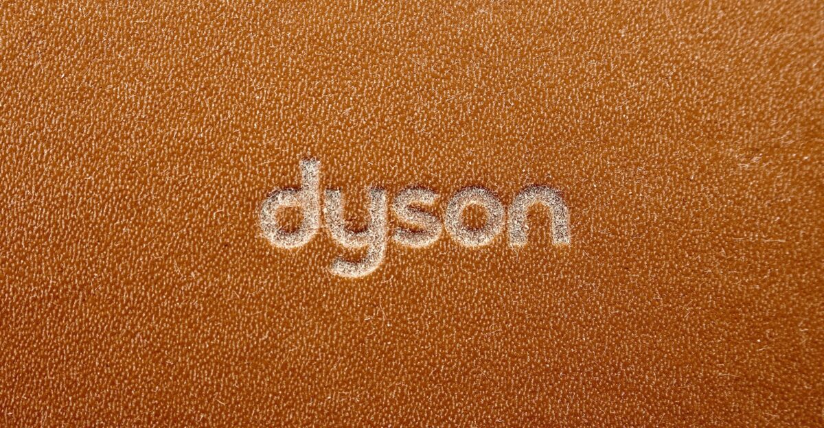 the word dyson written on a brown leather surface