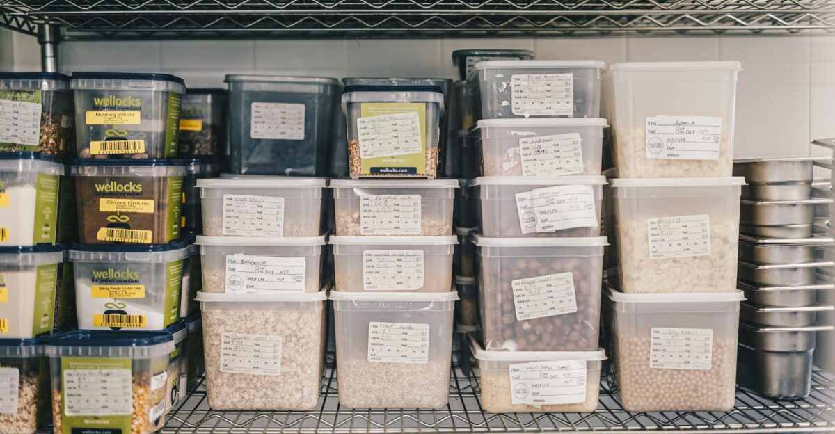 a shelf filled with containers and containers of food