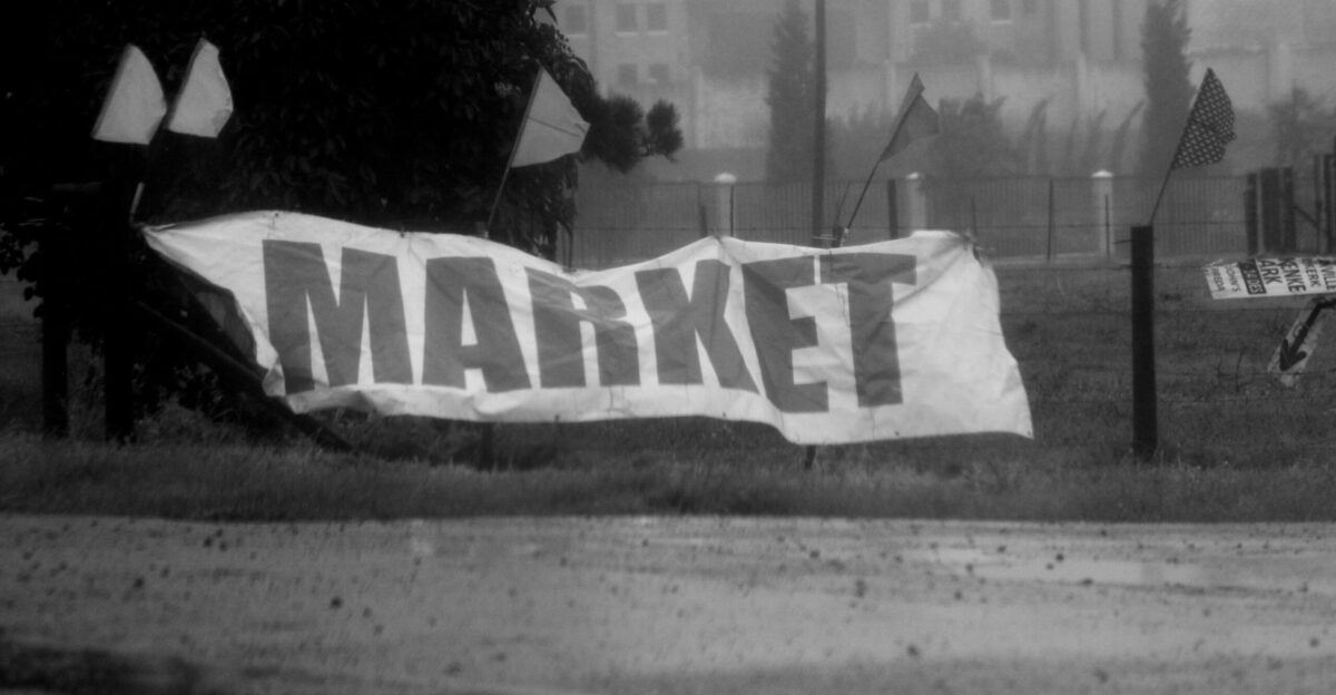 a black and white photo of a market sign