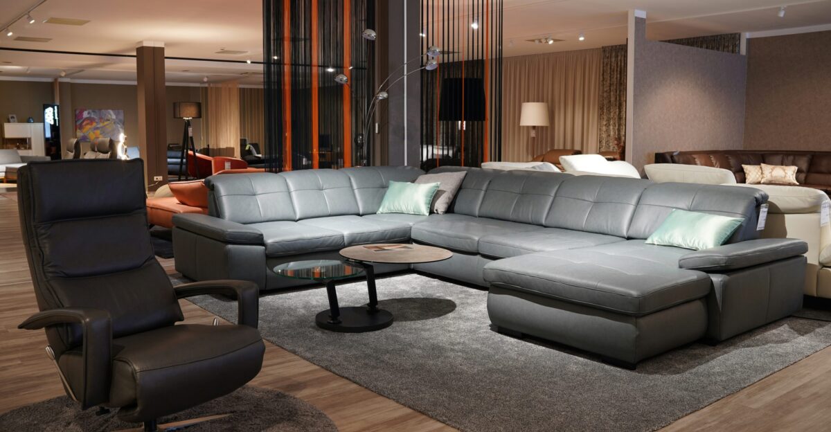 a living room filled with furniture and a wooden floor