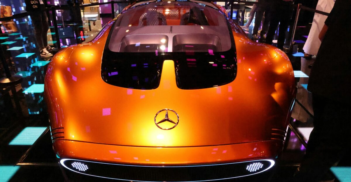 an orange sports car is on display at a show