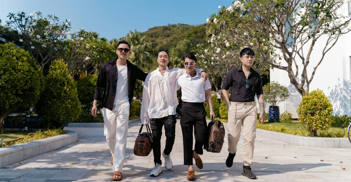a group of young men walking down a sidewalk