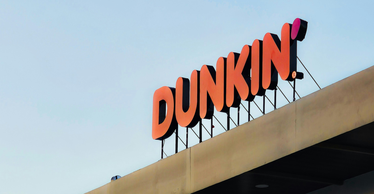 a dunkin'donuts sign on top of a building