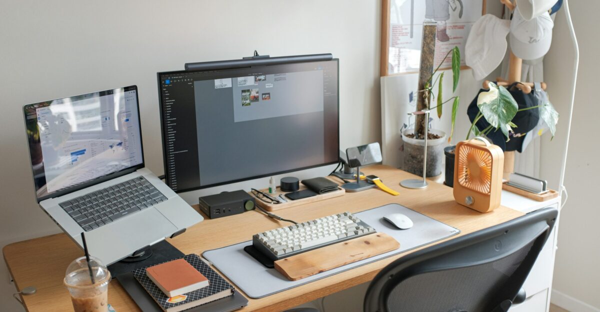 A desk with a laptop and a computer monitor