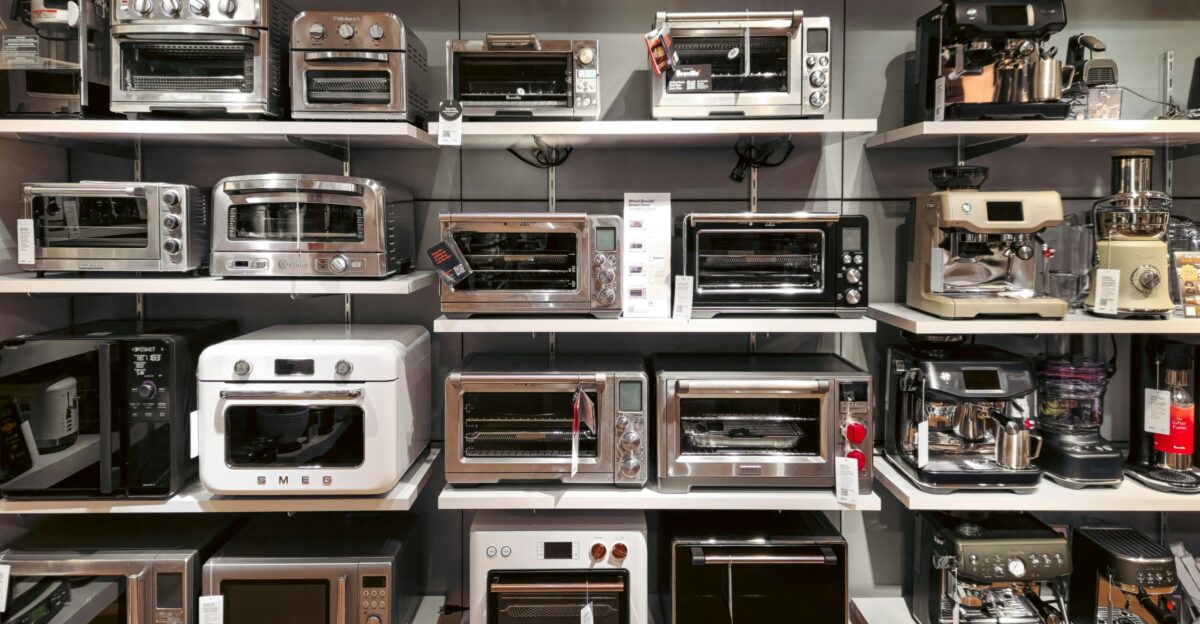 A bunch of microwaves that are on a shelf