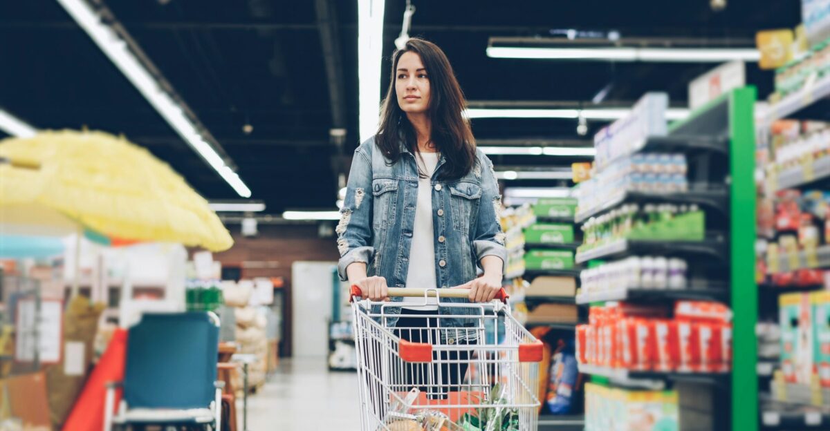 Woman shopping in a grocery store with a cart