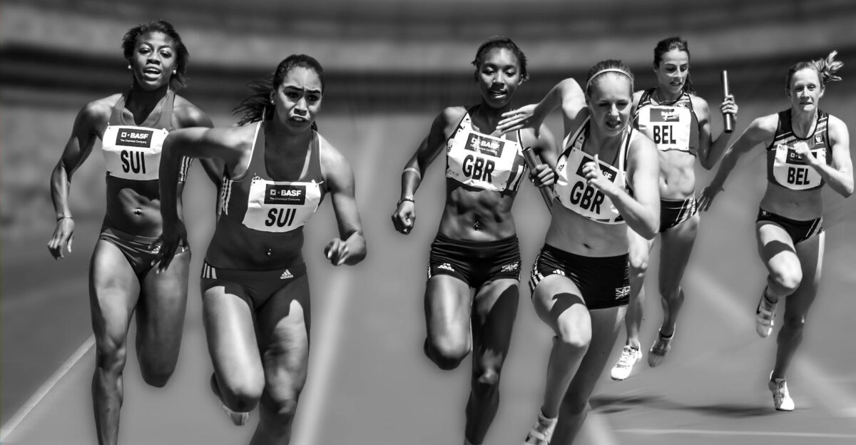 Female athletes in a high-stakes track race showcasing physical prowess and competition