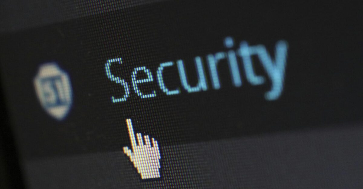 Close-up view of a mouse cursor over digital security text on display