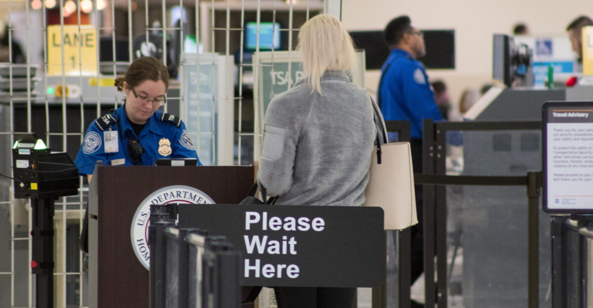 A Transportation Security Administration agent at a checkpoint verifying passenger identification John Glenn Columbus International Airport