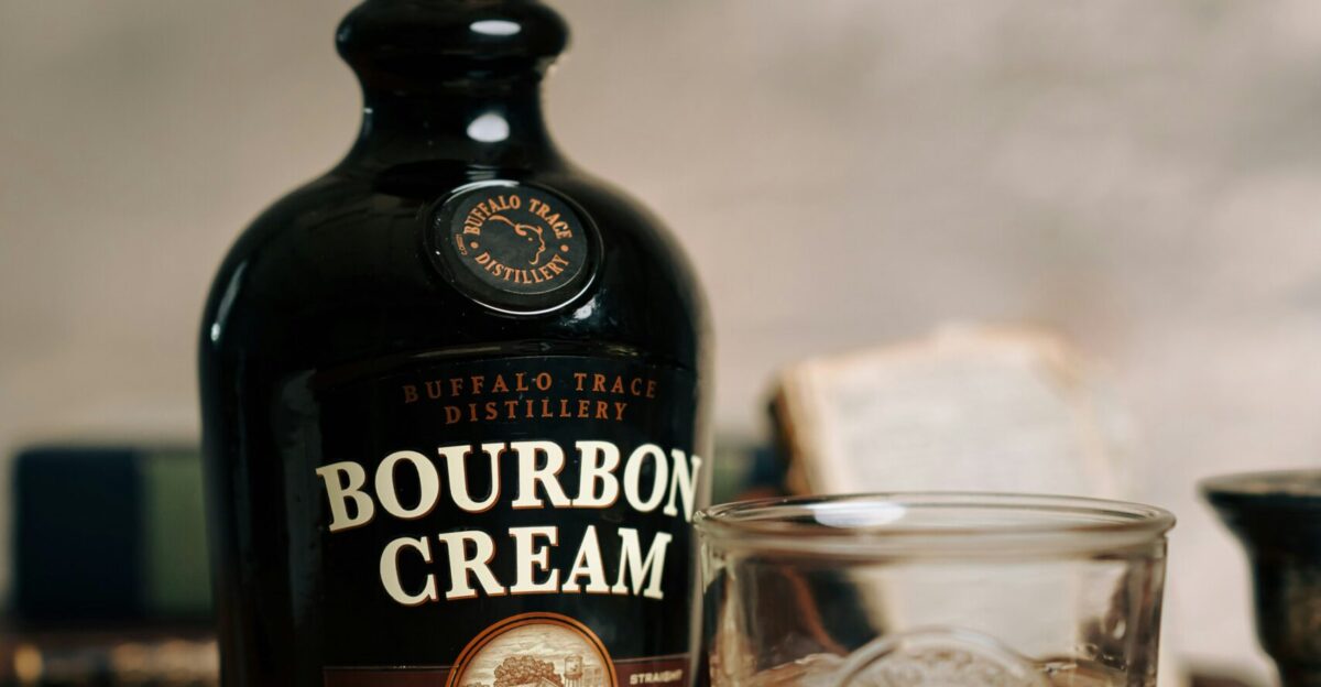 a bottle of bourbon cream next to a glass