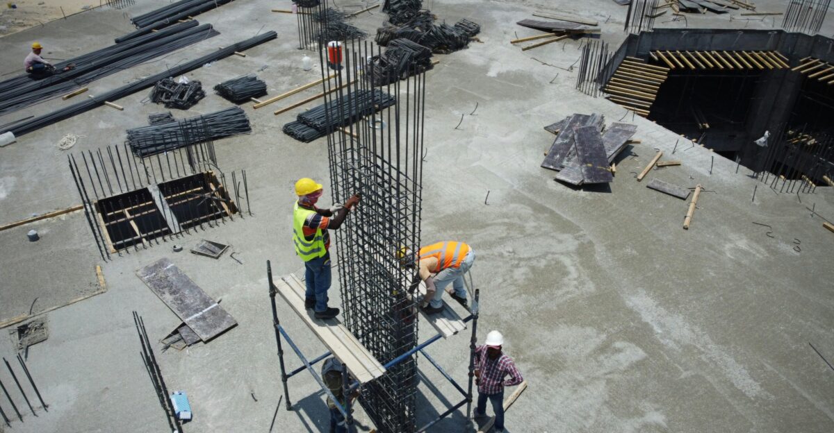a group of men standing on top of a construction site